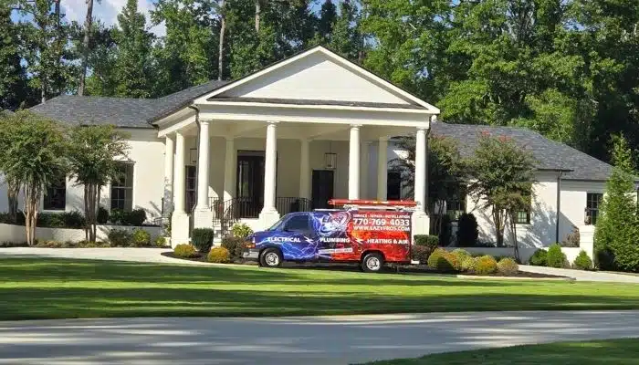 EaZy Pros truck in front of white, brick home with nice landscaping